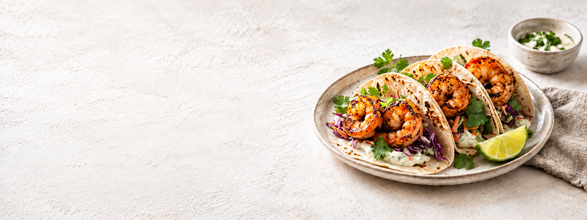 Char-grilled shrimp tacos on a ceramic plate
